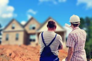 builders standing in front of a house discussing