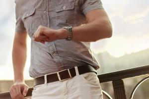 man checking the time on his watch